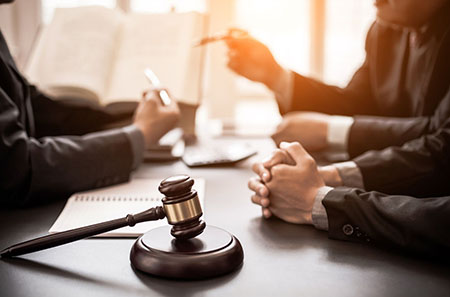 Photo of attorneys sitting with clients.